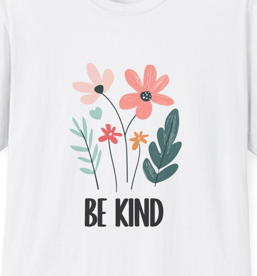 Close‑up of the soft pastel floral “Be Kind” artwork on a white tee.