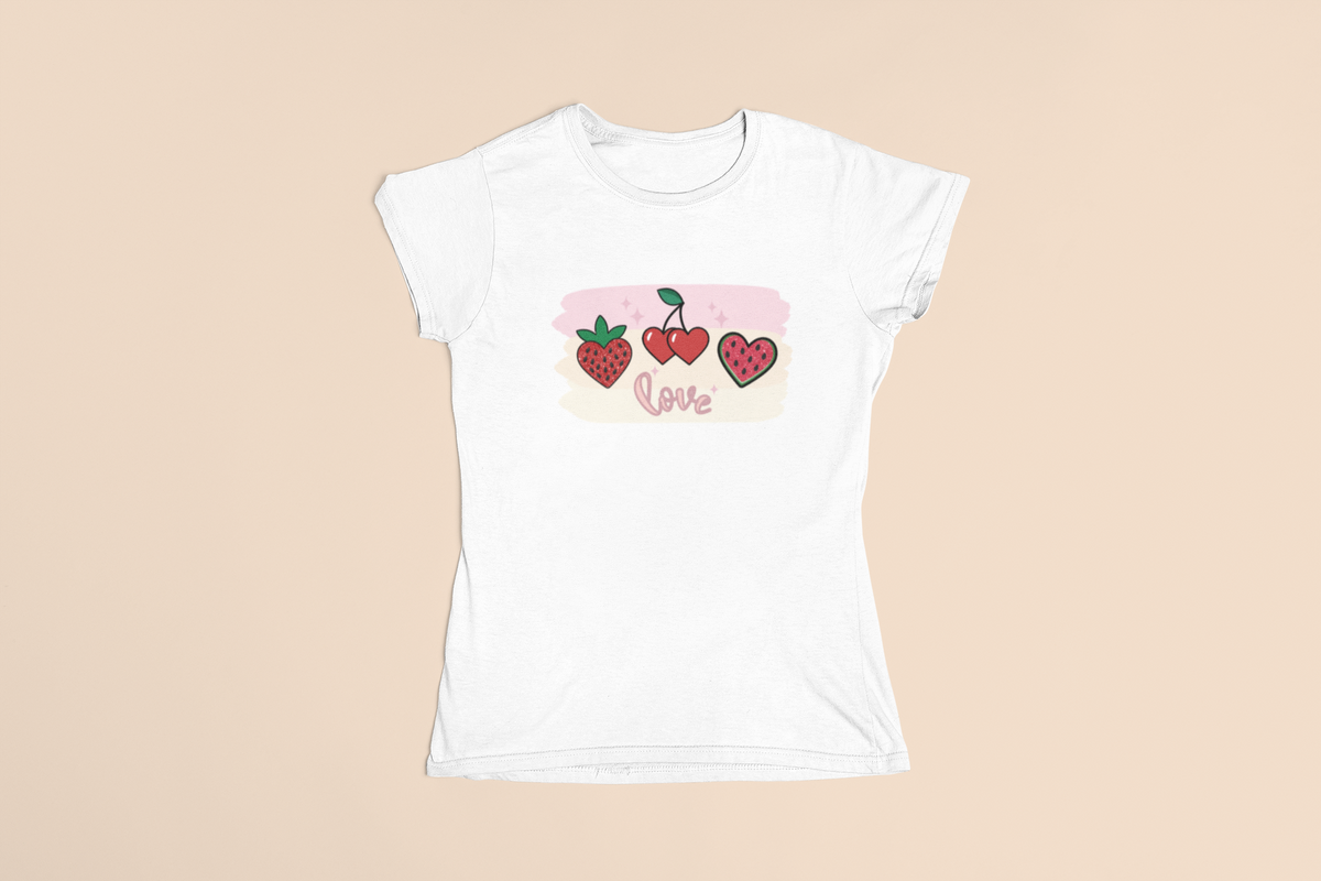White T‑shirt laid flat featuring a strawberry, a cherry, and a watermelon slice above the word ‘Love’ in cursive lettering.