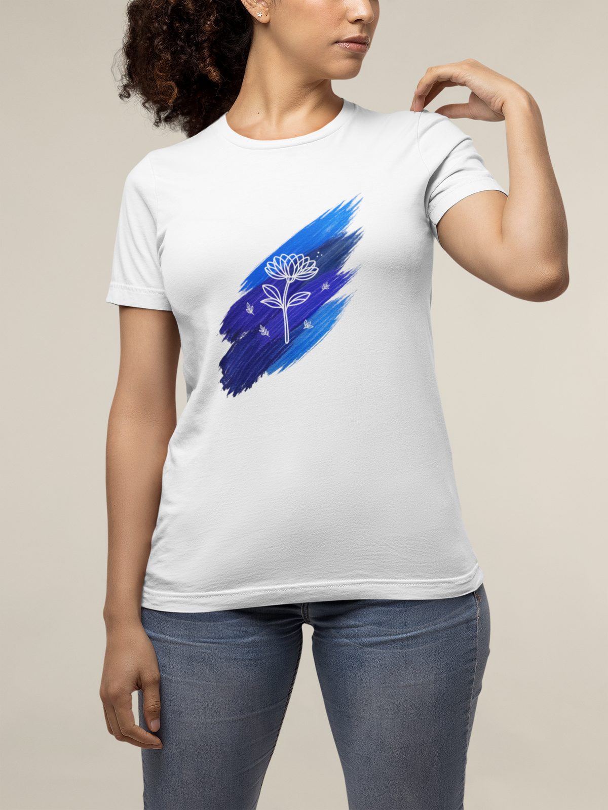 Model wearing the white Blue Brushstroke Lotus Tee in a natural setting, showing the blue brushstroke and white lotus design clearly.