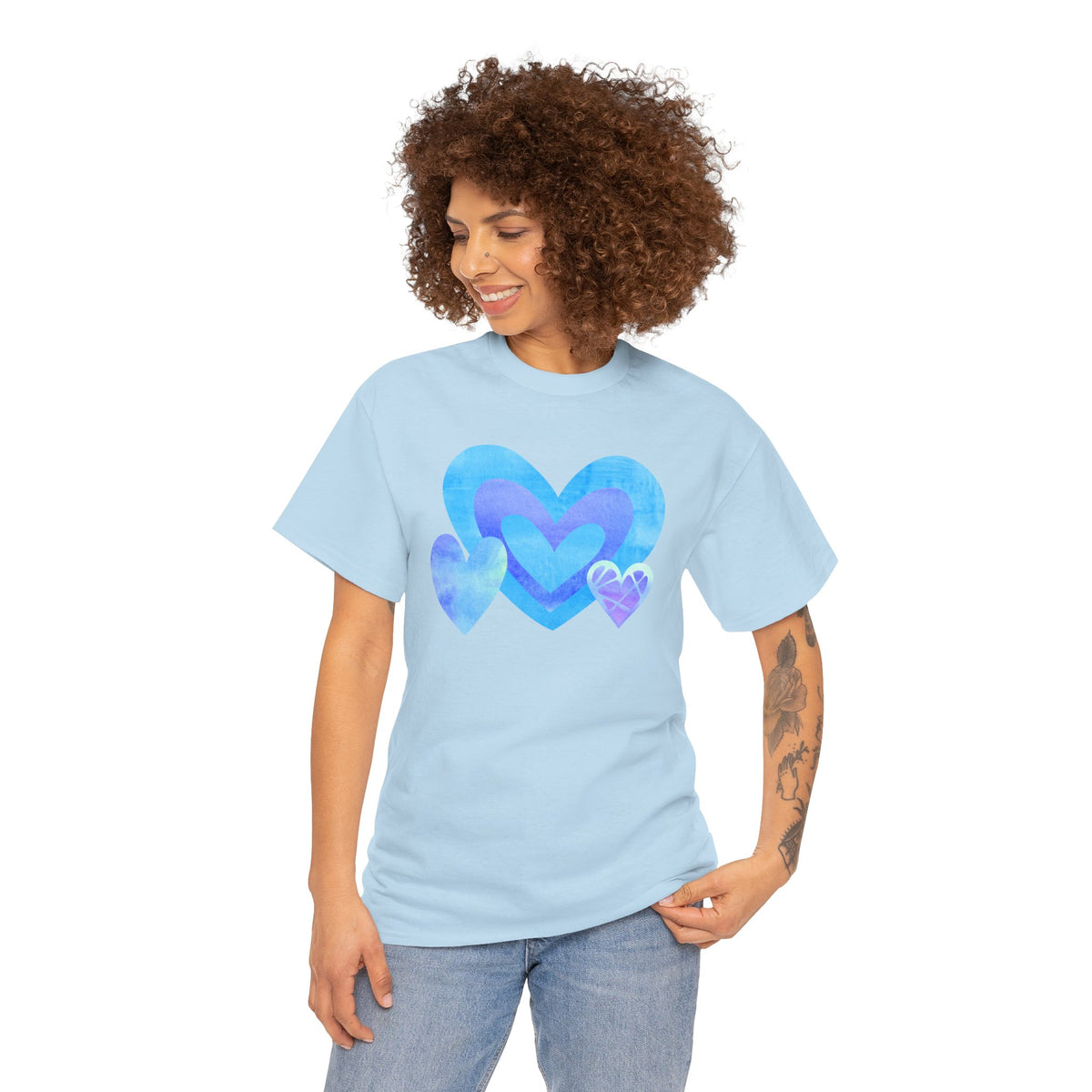 Model wearing the Light Blue tee with the layered blue, purple, and blush triple‑heart motif.