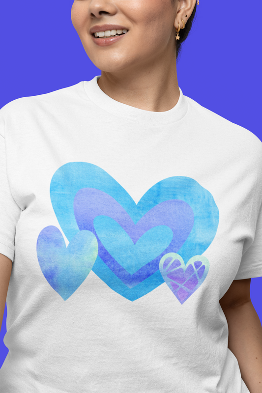  Model wearing the White tee featuring a layered blue, purple, and blush triple‑heart motif.
