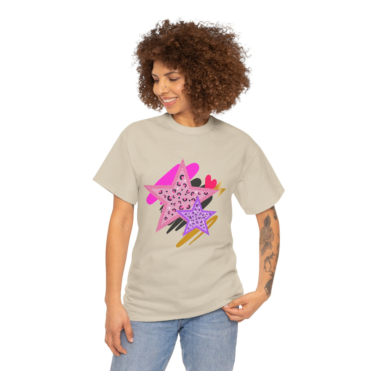 Model wearing Sand Leopard Star Tee showing pink and purple leopard‑print stars with textured brushstroke accents.