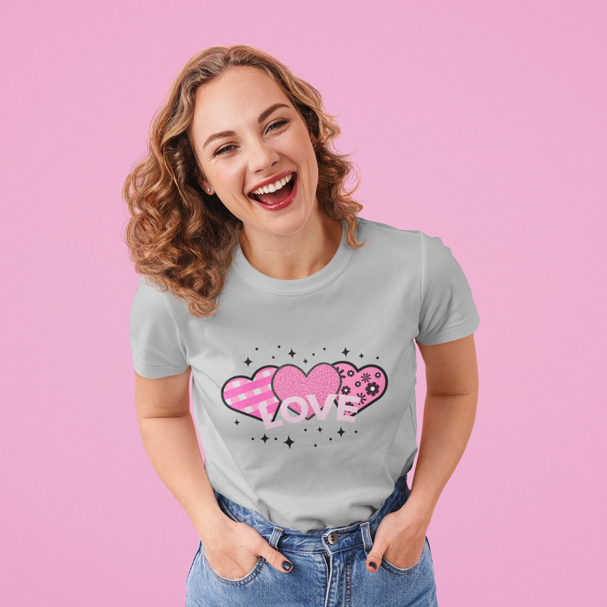 Model wearing the Grey tee featuring the pink LOVE heart trio motif.  