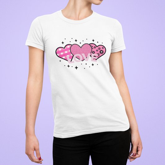 Model wearing the White tee featuring the pink LOVE heart trio motif. 