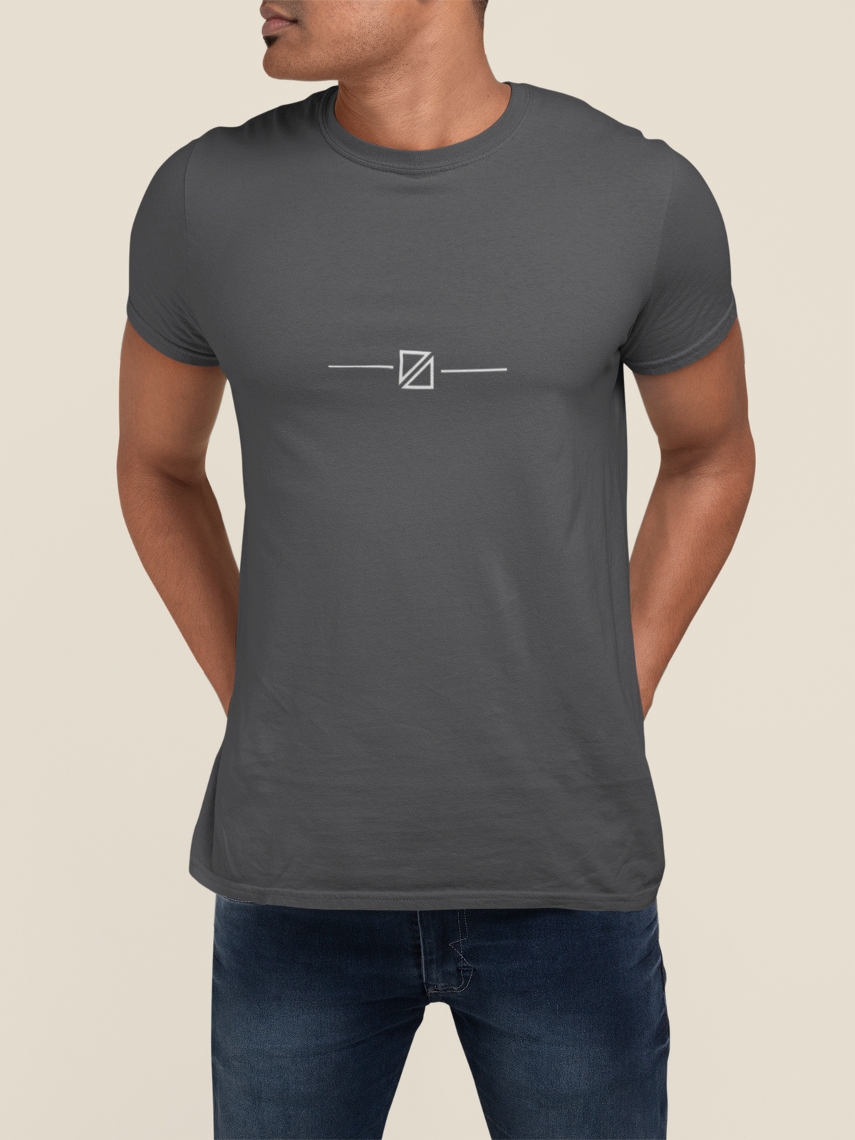 Model wearing the Minimal Geometric Crest Tee in Charcoal with minimal geometric linework crest on the chest.