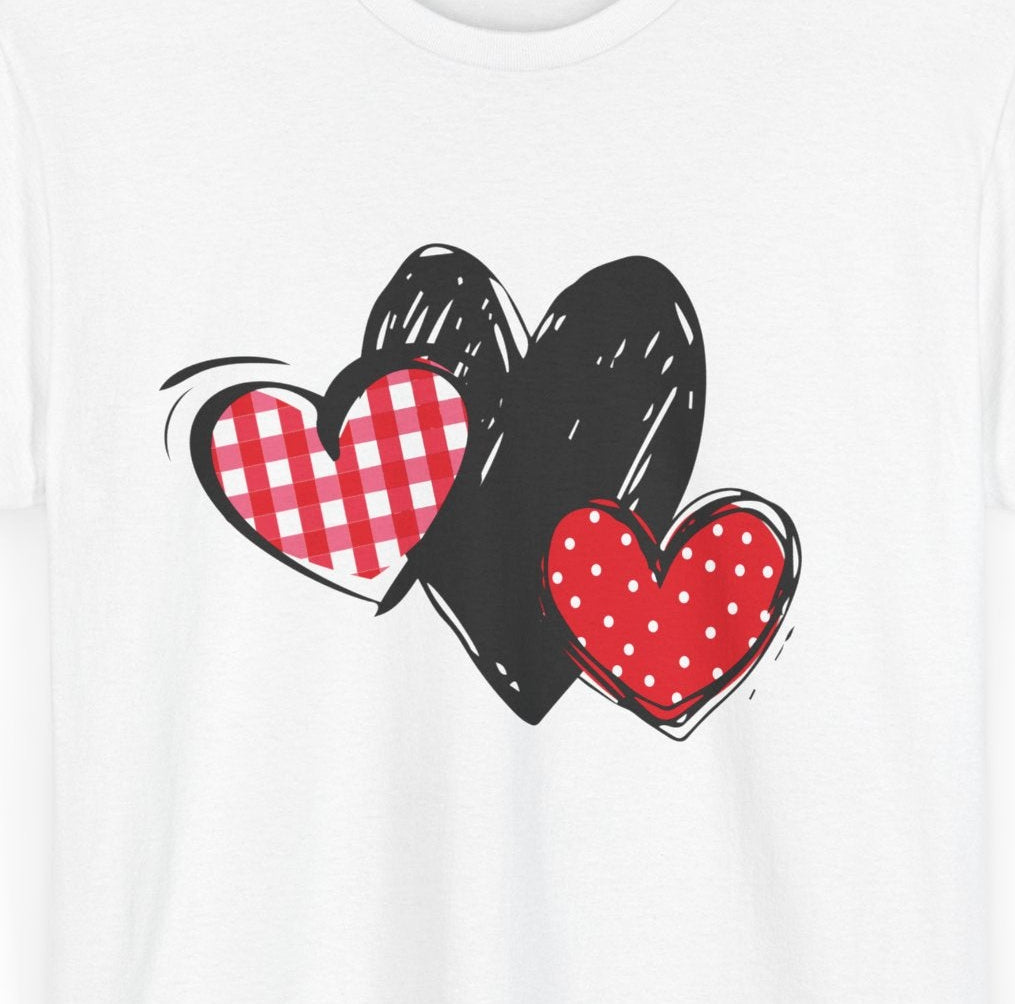 Close‑up of gingham, sketch, and polka dot triple‑heart pattern on T‑shirt fabric.