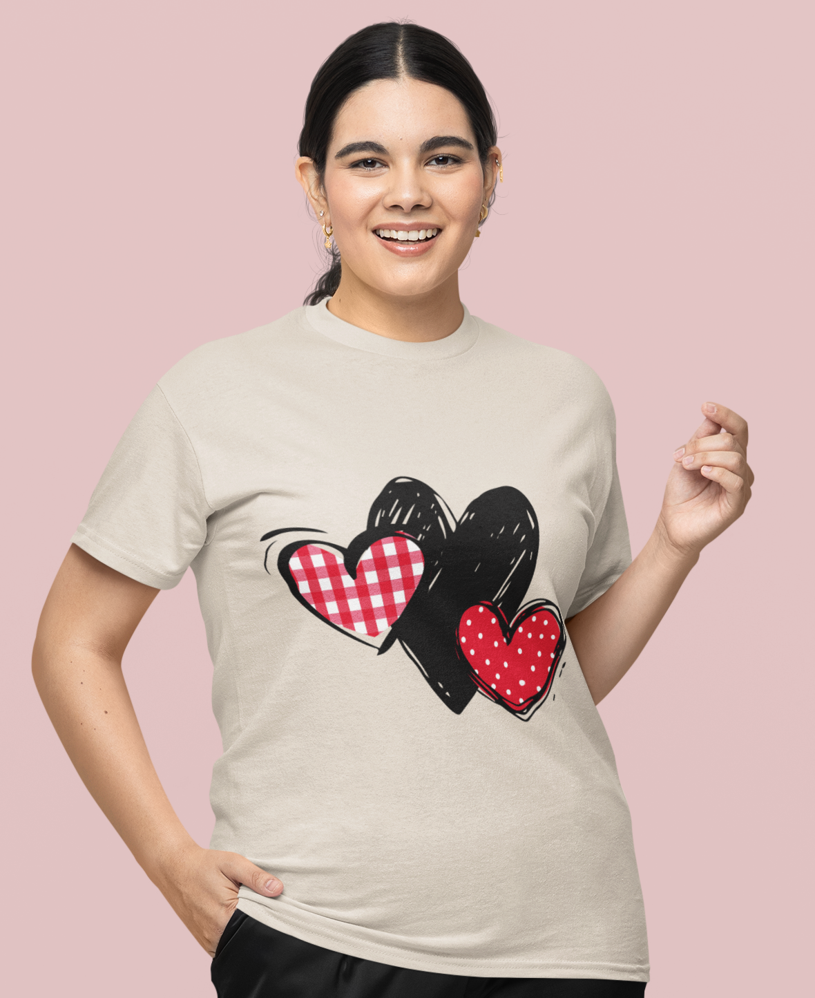 Sand T‑shirt featuring gingham, sketch, and polka dot triple‑heart design, worn by model.